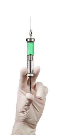 Syringe with a medicine in a hand, isolated on whiteの写真素材