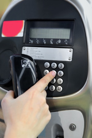 One human hand pressing key on phoneの写真素材
