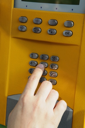 One human hand pressing key on phone の写真素材