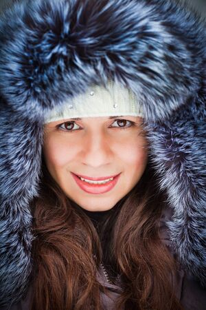 The beautiful girl in a cap in the winter の写真素材