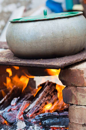 Outdoors cooked stew boiling on the fireの写真素材