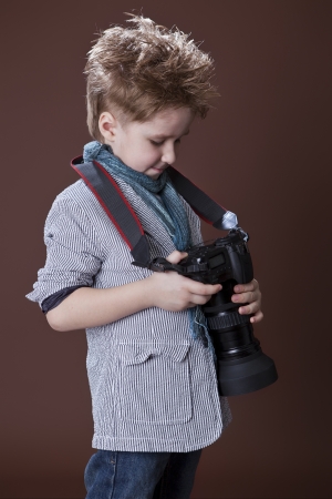 child in studio with professional cameraの写真素材
