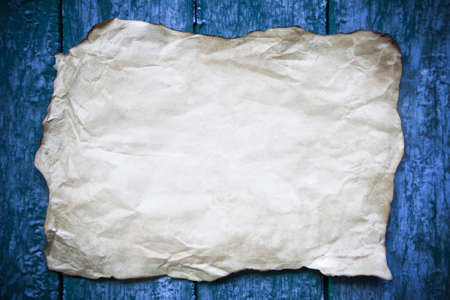 Old parchment on wooden backgroundの写真素材