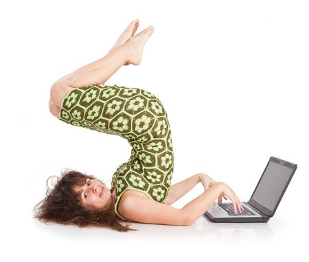 flexible beautiful girl with the laptop on a white backgroundの写真素材