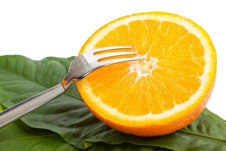 cut orange with a plug on leavesの写真素材