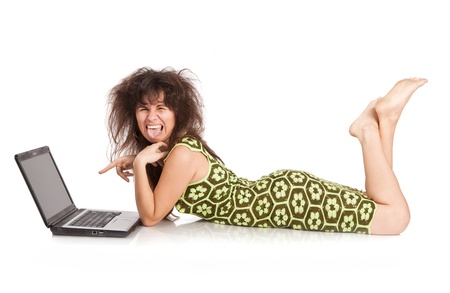  beautiful girl with the laptop lies on a floor isolated on a white backgroundの写真素材