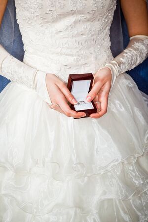 Girl with surprise looks at box with wedding ringの写真素材