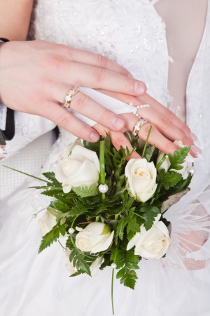 Hands and rings on wedding bouquetの写真素材