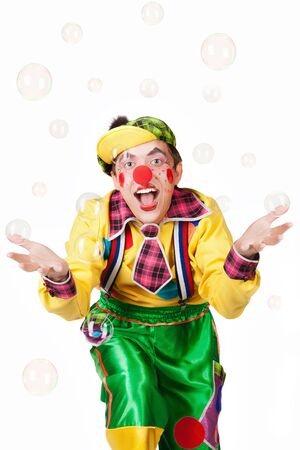 Cheerful clown in the soap bubbles isolated on a white backgroundの写真素材