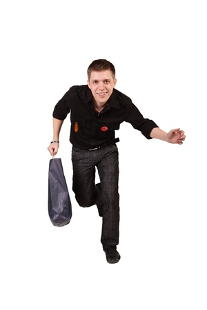 running guy with a bag in a hand isolated on a white backgroundの写真素材