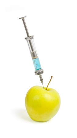 Syringes stuck in an apple の写真素材
