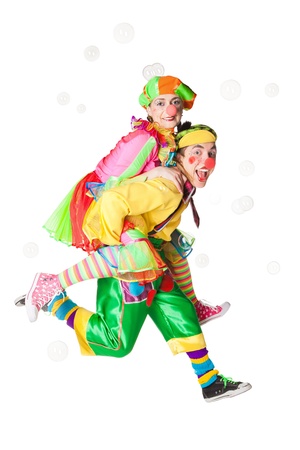 Two cheerful clowns  in the soap bubbles isolated on a white backgroundの写真素材
