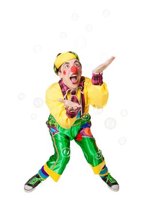 Cheerful clown in the soap bubbles isolated on a white backgroundの写真素材