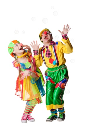 Two cheerful clowns  in the soap bubbles isolated on a white backgroundの写真素材