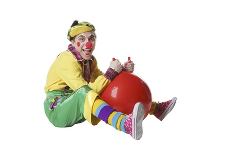 Funny clown with balls in studio isolated on white backgroundの写真素材