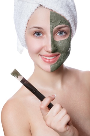 Young woman with facial mask in beauty spa isolated on a white backgroundの写真素材