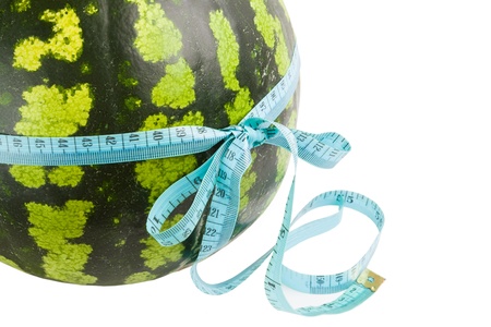 Watermelon wrapped around a measurement tape against white backgroundの写真素材