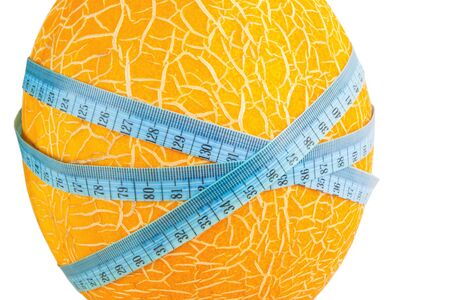 Close up fresh melon with measuring tape isolated on a white background. の写真素材