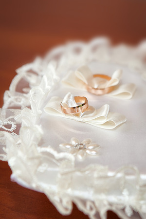 gold wedding rings on the pincushionの写真素材