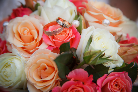 Wedding rings on a roseの写真素材