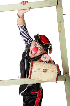 Clown in a pirate suit with chest isolated on a white backgroundの写真素材