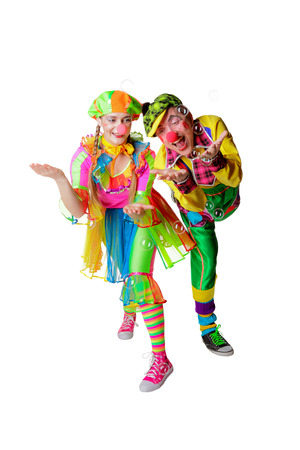 Two cheerful clowns in the soap bubbles isolated on a white backgroundの写真素材