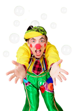 Cheerful clown in the soap bubbles isolated on a white backgroundの写真素材