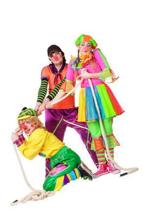 Three smiling clowns isolated over a white backgroundの写真素材