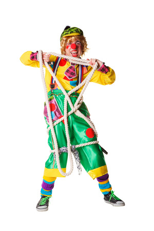 Cheerful clown got confused in a rope isolated on a white backgroundの写真素材