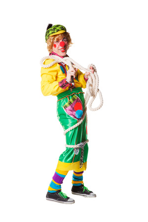 Cheerful clown got confused in a rope isolated on a white backgroundの写真素材