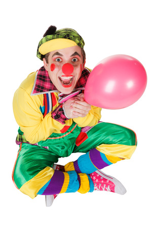 clown with a balloon in a hand isolated on a white backgroundの写真素材