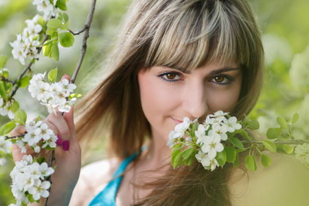 Blonde Girl with Cherry Blossom  Spring Portrait  Beautiful Young Woman with Sakura  Outdoorの写真素材