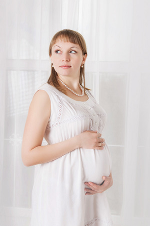 pregnant woman caressing her bellyの写真素材