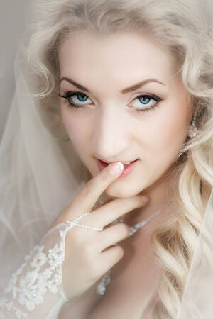Portrait of the bride close up with a finger on lipsの写真素材