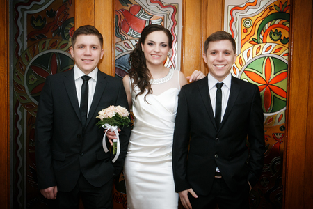 Portrait of the groom with the bride and the brother of the groom of the twinの写真素材