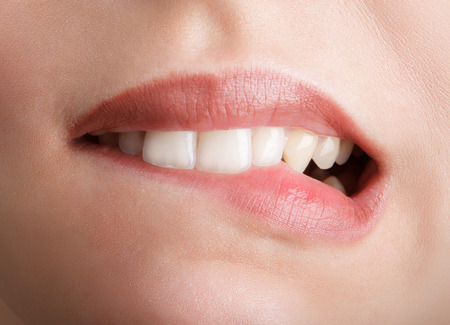 Biting her red lips teethの写真素材
