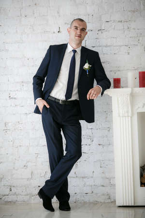 groom standing near fireplaceの写真素材