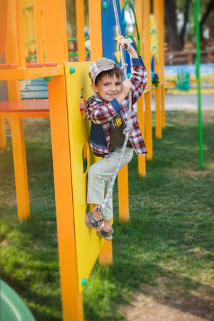 Happy games - pretty boy in cap on the playgroundの写真素材