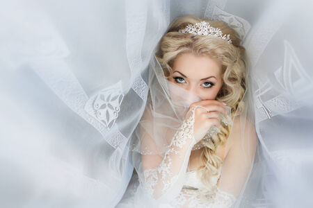 Portrait of the bride close up which was covered with a veilの写真素材