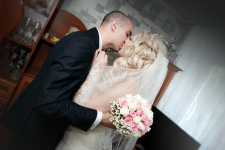 Kiss of the groom and the bride in their wedding dayの写真素材