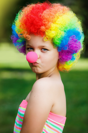 little girl in clown wigの写真素材