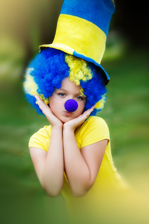 little girl in clown wig and hatの写真素材