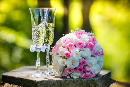 Wedding rings with roses and glasses of champagneの写真素材