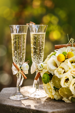 Wedding rings with roses and glasses of champagneの写真素材