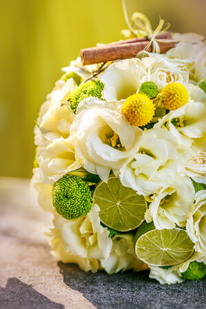 Wedding bouquet from beige roses, cinnamon, a lemon, a limeの写真素材