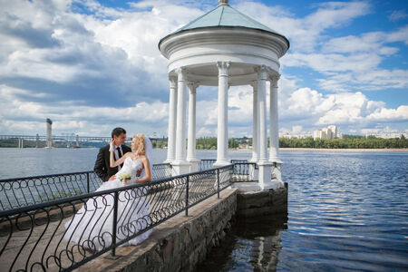 The groom and the bride at the river pierの写真素材