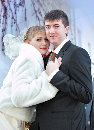 Happy bride and groom on wedding day sky backgroundの写真素材