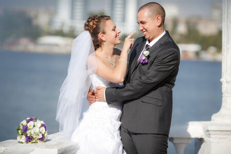 The groom and the bride on a beach in their wedding dayの写真素材