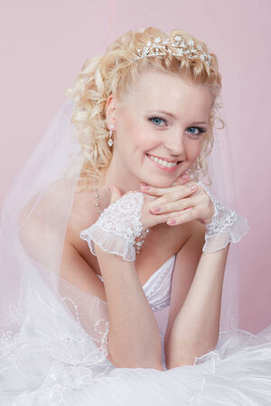 studio portrait of a happy bride on a pink backgroundの写真素材