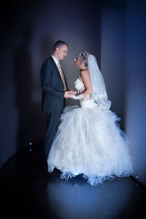 happy bride and groom in the modern hotel hallの写真素材